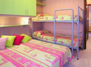 a room with two bunk beds in a room at Appartamenti Paola in Bibione
