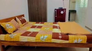 ein Bett mit einer bunten Decke darüber in der Unterkunft RN GUEST HOUSE ARAMBOL GOA in Arambol