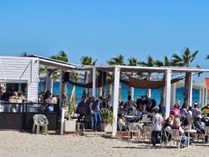 a group of people sitting at tables on the beach at Alicante 10 in Alicante +4 photos