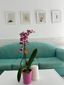 a living room with a couch and a table with flowers at Maria's Apartments in Pigi