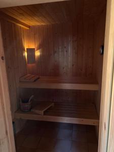 a wooden sauna with a bench in a room at Chalet Stickie by Swiss Alps Village in Hérémence