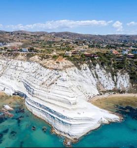 an aerial view of a beach with white cliffs at La Trinacria in Agrigento