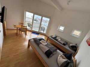 a room with two beds and a dining room with a table at Pension Schweizer in Laupheim