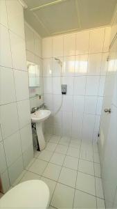 a bathroom with a shower and a toilet and a sink at 逢甲馨宿 in Hsia-shih-pi