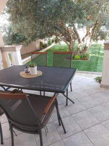 a black table and chairs on a patio at Apartmani Delač in Vodice