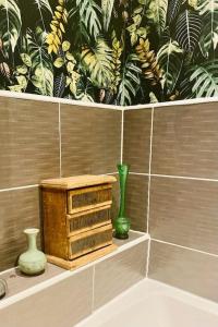 a bathroom with vases on a shelf with a tile wall at Fairford House - 4 Bed House - Close to the Racecourse in Cheltenham