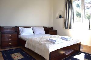 a bedroom with a bed with two towels on it at Villa Corali II in Pefkali +20 photos