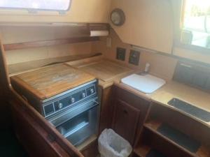 a small kitchen with a stove and a sink at Sailboat Experience in Annapolis in Annapolis