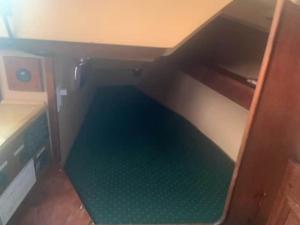 a small room with a green floor underneath a desk at Sailboat Experience in Annapolis in Annapolis
