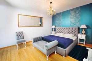 a bedroom with a bed and a couch and a mirror at Hotel Mikołaj in Kraków +32 photos