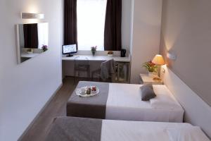 Postel nebo postele na pokoji v ubytování Hotel Mennini + 37 fotografií