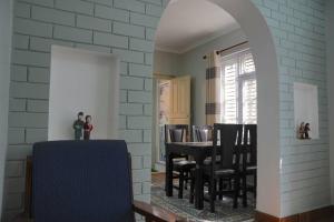 a dining room and kitchen with a table and chairs at Anita's Home in Kathmandu