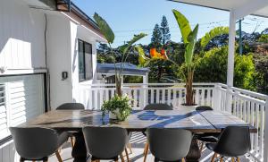 a wooden table and chairs on a balcony with a table at Rye's Villa in Rye