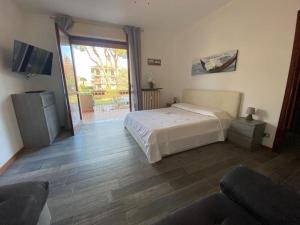 a bedroom with a bed and a sliding glass door at La terrazza con le biciclette a due passi dal lago in Arona