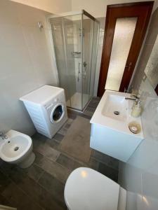 a bathroom with a toilet and a sink and a shower at La terrazza con le biciclette a due passi dal lago in Arona