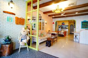 a teddy bear sitting on a chair in a room at 洄瀾雅舍民宿-近火車站-東大門夜市附近 in Hualien City