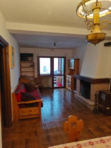 a living room with a couch and a fireplace at Ciasa de Carla in Masarè