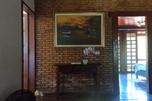 uma parede de tijolos com lareira numa sala de estar em Casa Muro de Pedra / Cabrália em Santa Cruz Cabrália