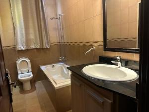 a bathroom with a sink and a toilet at Cento Stalloni in Kigali