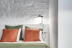 a bedroom with a bed with orange pillows at Luxury 1BR BORN in Barcelona
