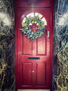 a red door with a wreath on it at Studio flat in London in London