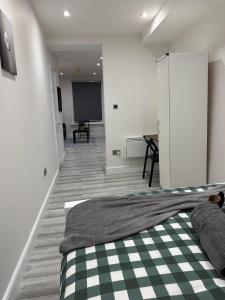 a bedroom with a bed and a tv in a room at Studio flat in London in London