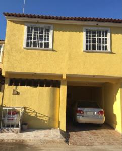 a car parked in a garage in front of a house at BEAUTIFUL HOME FULLY FURNISHED, READY TO RELAX AND 5 MINUTES FROM THE BEACH!! in Ixtapa