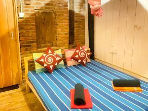 a bed with colorful pillows on it in a room at Amaranthe Beach Cabanas in Galle