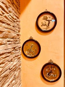 two clocks on the wall of a building at Isolabella in Mazara del Vallo
