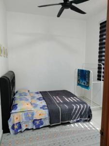 1 dormitorio con 1 cama y ventilador de techo en Dedaun Homestay Perlis, en Kangar
