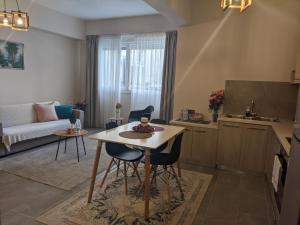 a kitchen and living room with a table and chairs at Aristo Central Apartments in Ioannina
