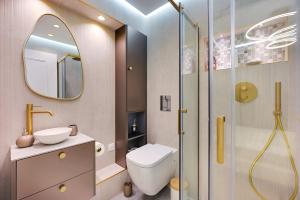 a bathroom with a shower and a toilet and a sink at Bretagne Mairie du 3e in Paris