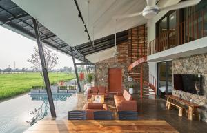 a house with a living room and a pool at Champ Villa Long An in Ấp Bình Yên