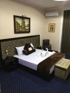 ein Hotelzimmer mit einem großen Bett und einem Stuhl in der Unterkunft Paradise Boutique Hotel in Kairo