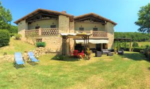 a large house with chairs in front of it at Villa Tilla in Gualdo Cattaneo