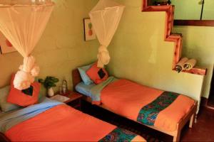 two twin beds in a room at Explorers River Camp in Jinja