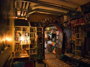 an archway in a room filled with books at Le Flâneur Guesthouse in Lyon