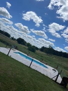 a swimming pool in the middle of a field at Casa quinta Don bosco in Tandil