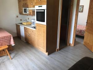 une cuisine avec des armoires en bois et un comptoir dans l'établissement Beau 3 pièces avec vue Montana 4, à Pralognan-la-Vanoise