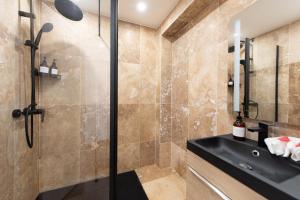a bathroom with a shower and a sink at LE COCON- Jacuzzi & Sauna privés By SweetDreams in Le Cannet