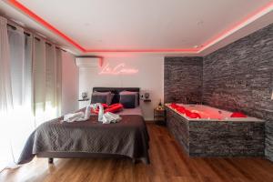 a bedroom with a bed and a bath tub at LE COCON- Jacuzzi & Sauna privés By SweetDreams in Le Cannet