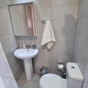 a small bathroom with a sink and a toilet at the heart of Heraklion in Heraklio