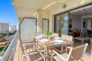 a dining room with a table and chairs on a balcony at Mileni Atico Duplex Roses - Immo Barneda in Roses