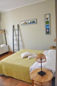 a bedroom with a bed and a table with a lamp at Casa Dona' Penne in Penne