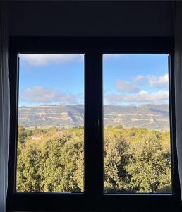 a window with a view of a mountain view at Montanyà in Seva