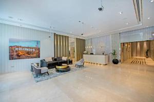 a lobby with a couch and chairs in a building at Chic One Bedroom Apartment with Full Sea View in Dubai