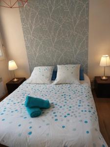 a bedroom with a bed with blue sheets and blue pillows at Suite Molinel in Lille