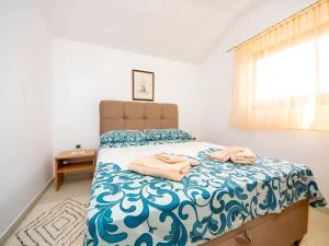 a bedroom with a bed with towels on it at Apartment Jadria near the beach in Šibenik