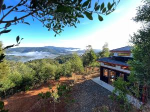a house on a hill with a view of the mountains at Cabañas japonesas en el bosque KURO y AKA in Valdivia