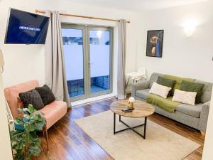 a living room with a couch and a table at Stunning 1 Bed flat in Canary Wharf FREE parking in London